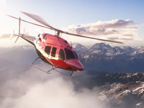 Helicopter flying over snowy mountains