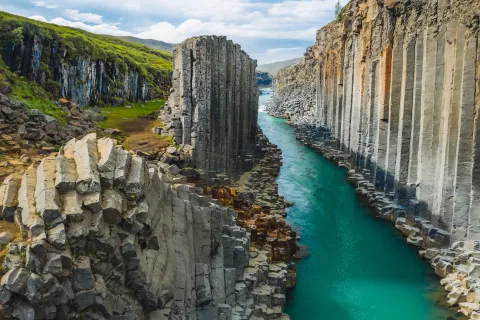 View of Stuðlagil canyon's basalt columns and river near Egilsstaðir