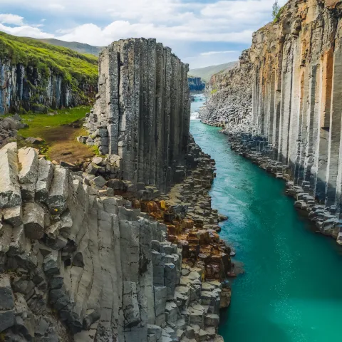 View of Stuðlagil canyon's basalt columns and river near Egilsstaðir